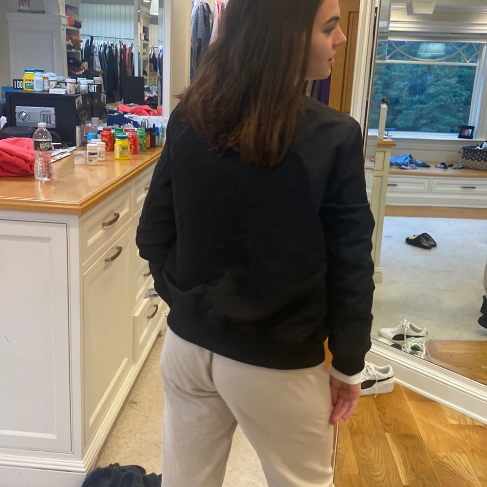 Block bomber jacket with a gold zipper and a pocket on side of the arm